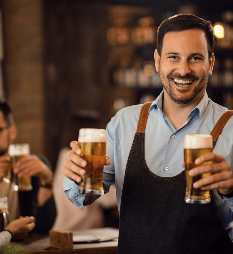 Waiter delivering beers during happy hour